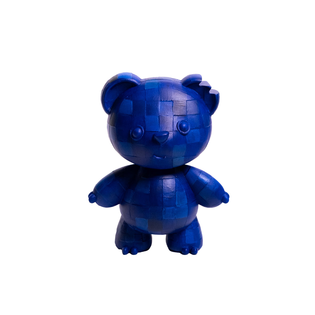 A small blue bear-shaped collectible figure made of blocky, pixelated pieces, centered on a plain white background.