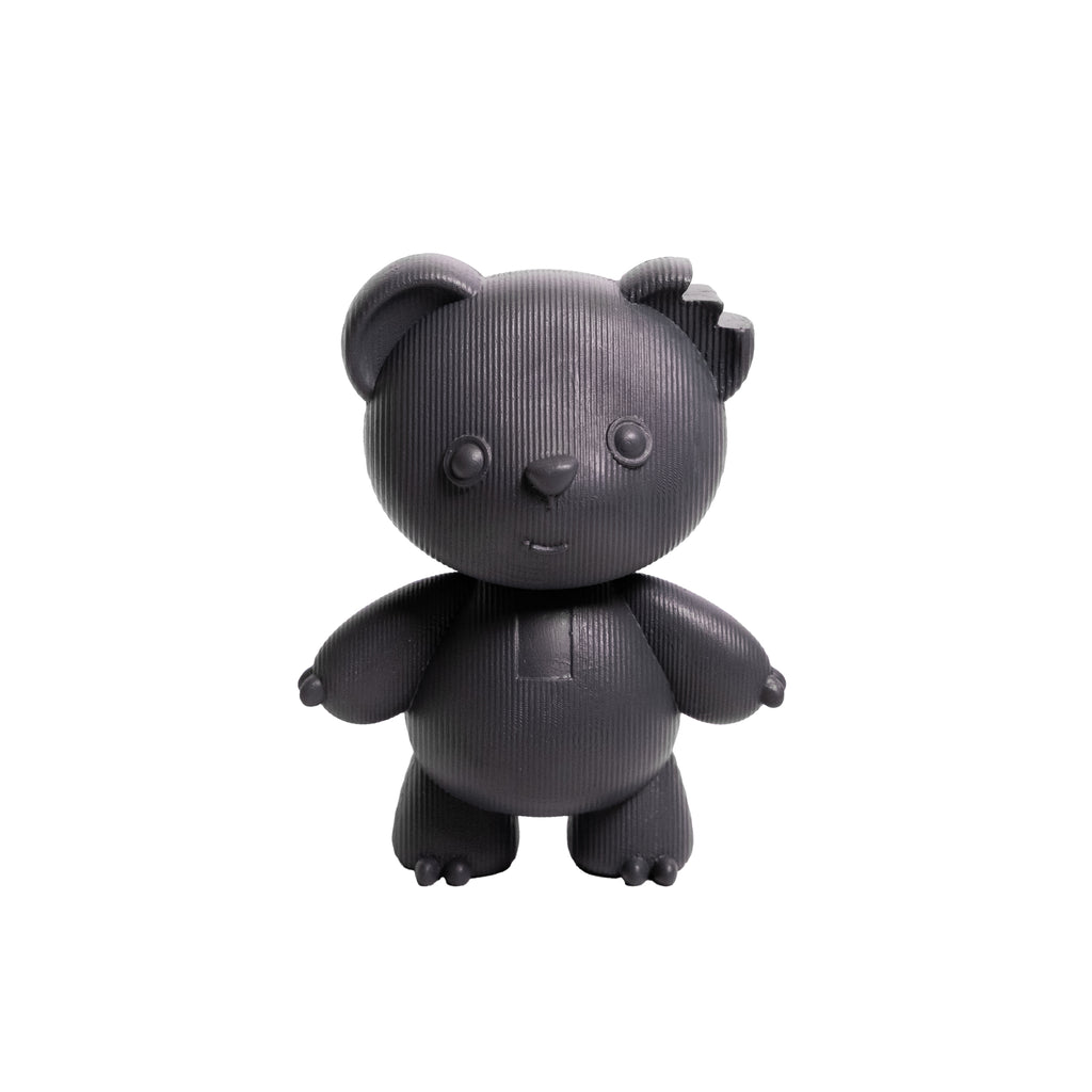 A small black bear-shaped figurine with a ribbed texture, standing against a plain white background.