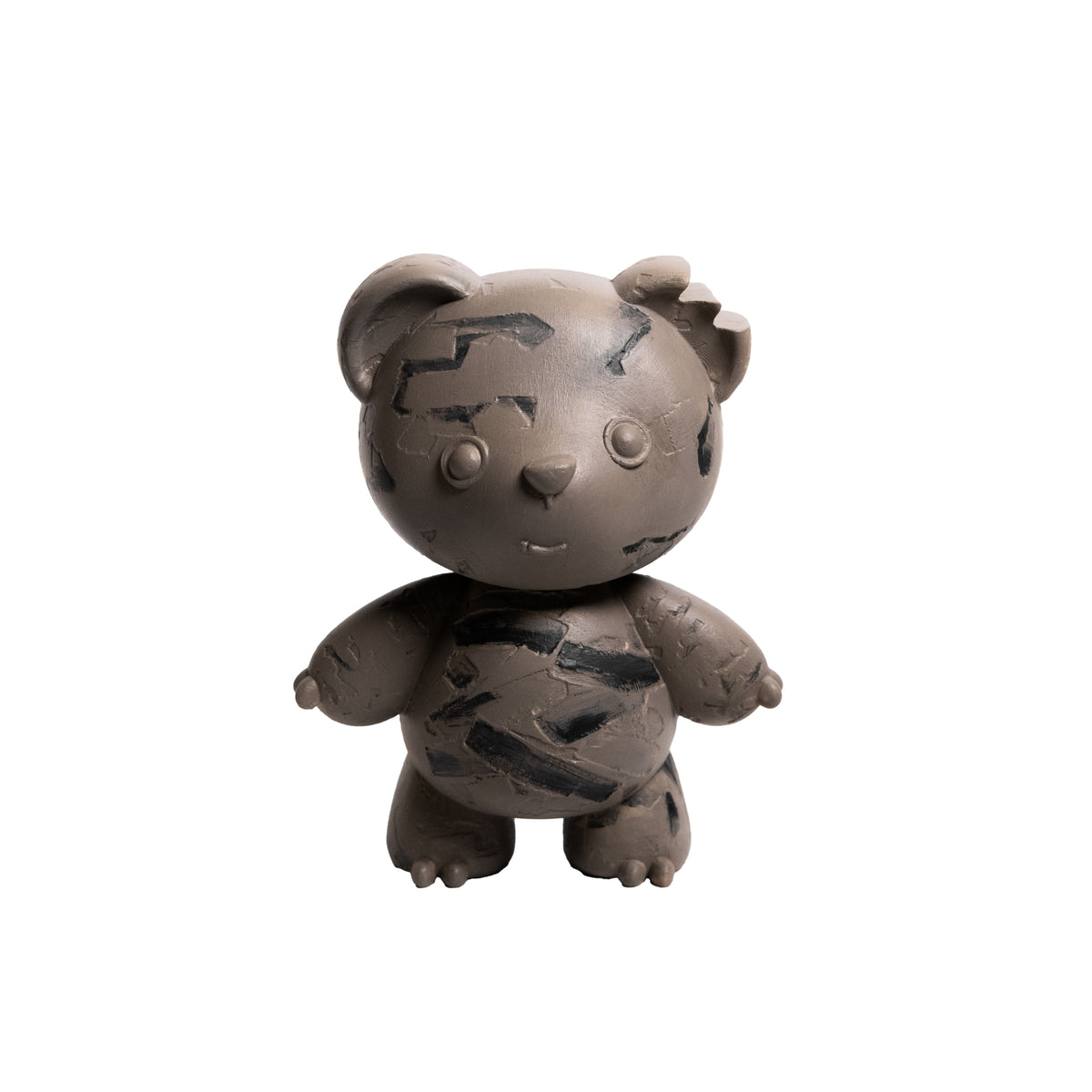 A small stylized bear figurine in a matte taupe-brown color with dark charcoal black abstract scratch-like markings across its face, chest, and limbs, shown against a plain white background.