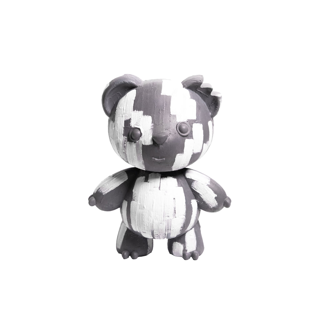 A small stylized bear figurine with a black and white brushstroke pattern, standing against a plain white background.