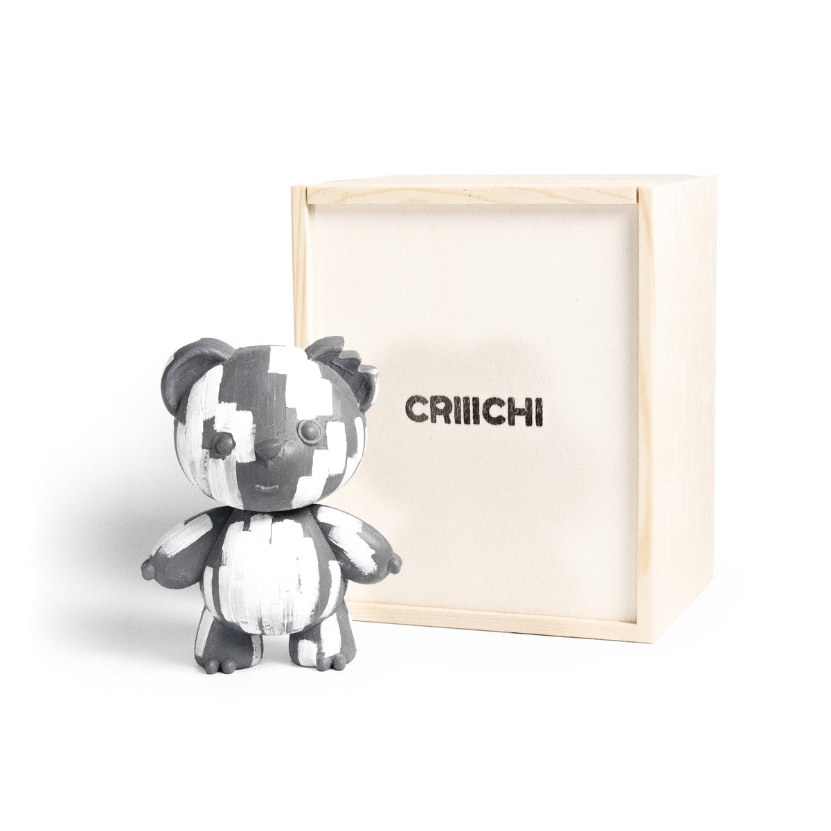 A white brush stroke bear figurine in black and white stands in front of its light wood box, which has the brand name 'CRIIICHI' printed on it, set against a plain white background.