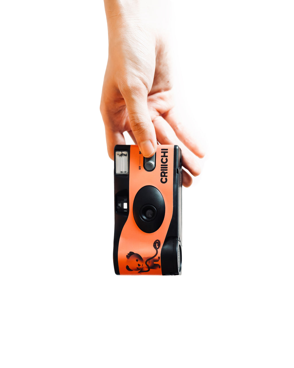 Hand holding an orange and black disposable film camera against a white background