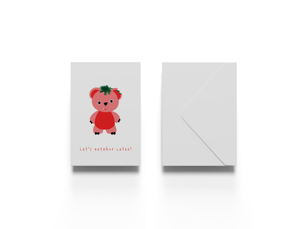Greeting card with a teddy bear with tomato skins illustration saying let's ketchup later along with a white envelope