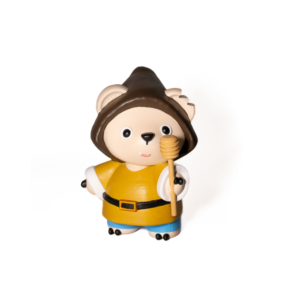 Designer toy bear figurine dressed as a gnomes holding a honey dipper