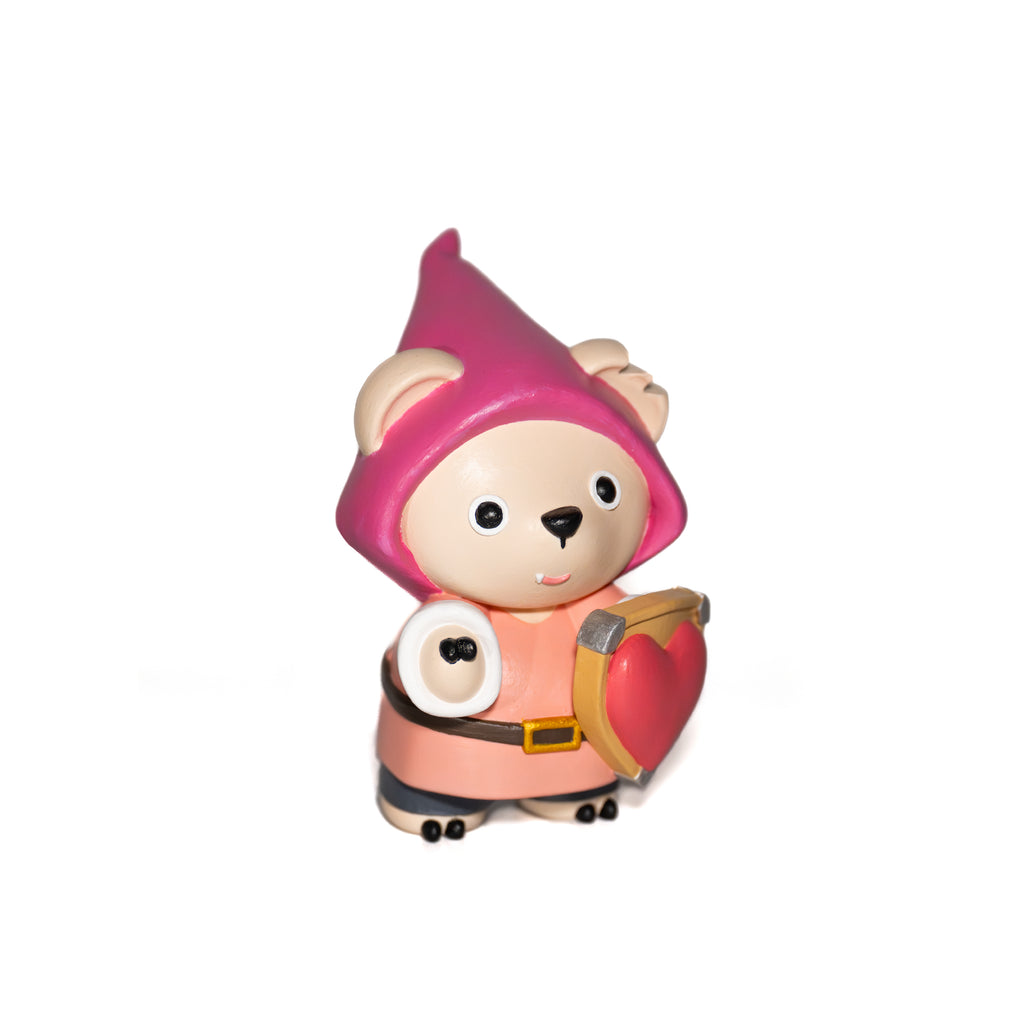 Toy figure of a character holding a heart shaped shield with a pink hat and red gnomes seasonal outfit