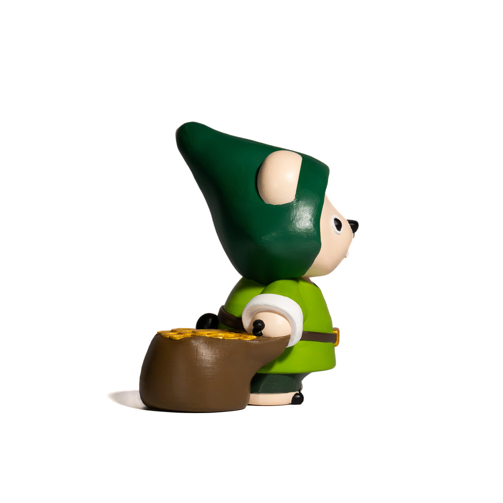 Toy figure of a character with a green hat and outfit, holding a pot of gold on a white background