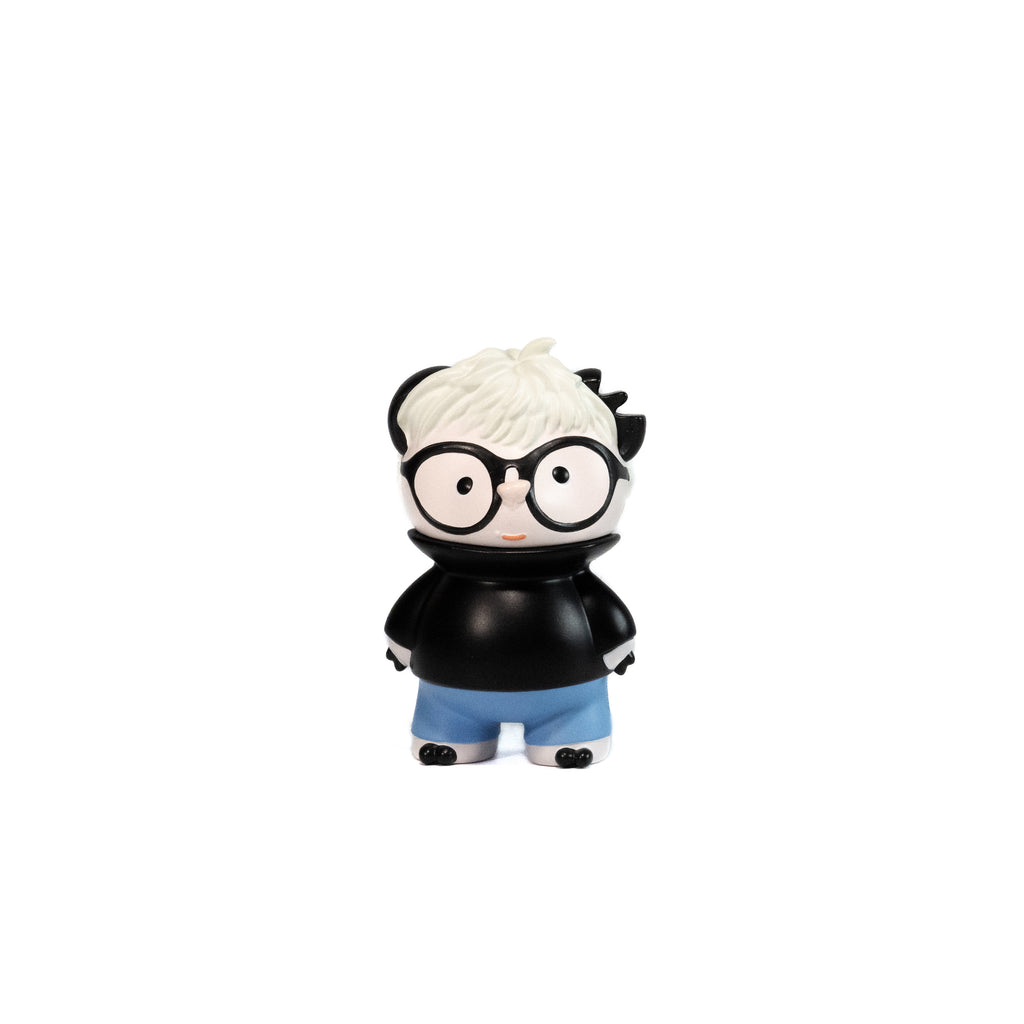 Toy figure of a character with glasses and a black shirt inspired by Andy Warhol